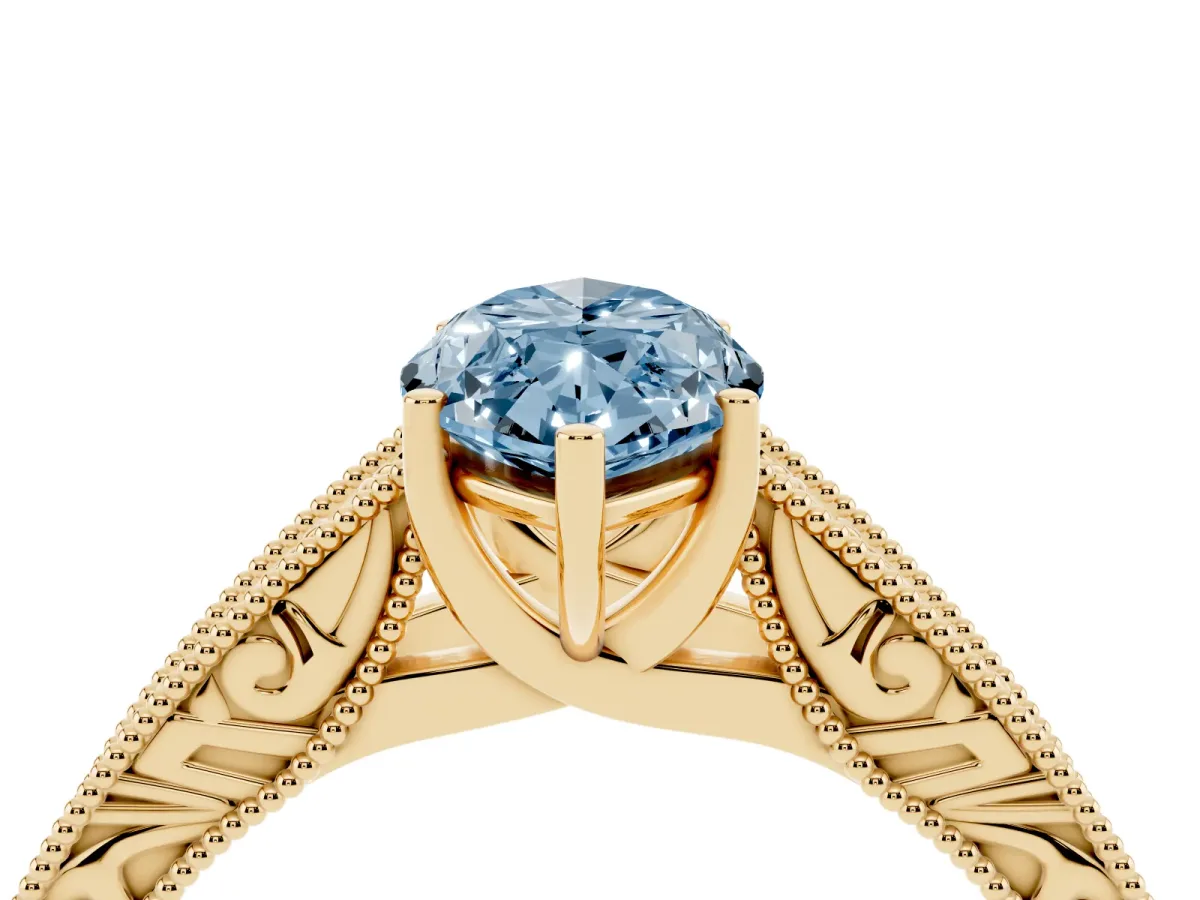 Fancy Blue Marquise Cut Diamond Solitaire Ring with Engraved Band and Four-Prong Setting Yellow gold
