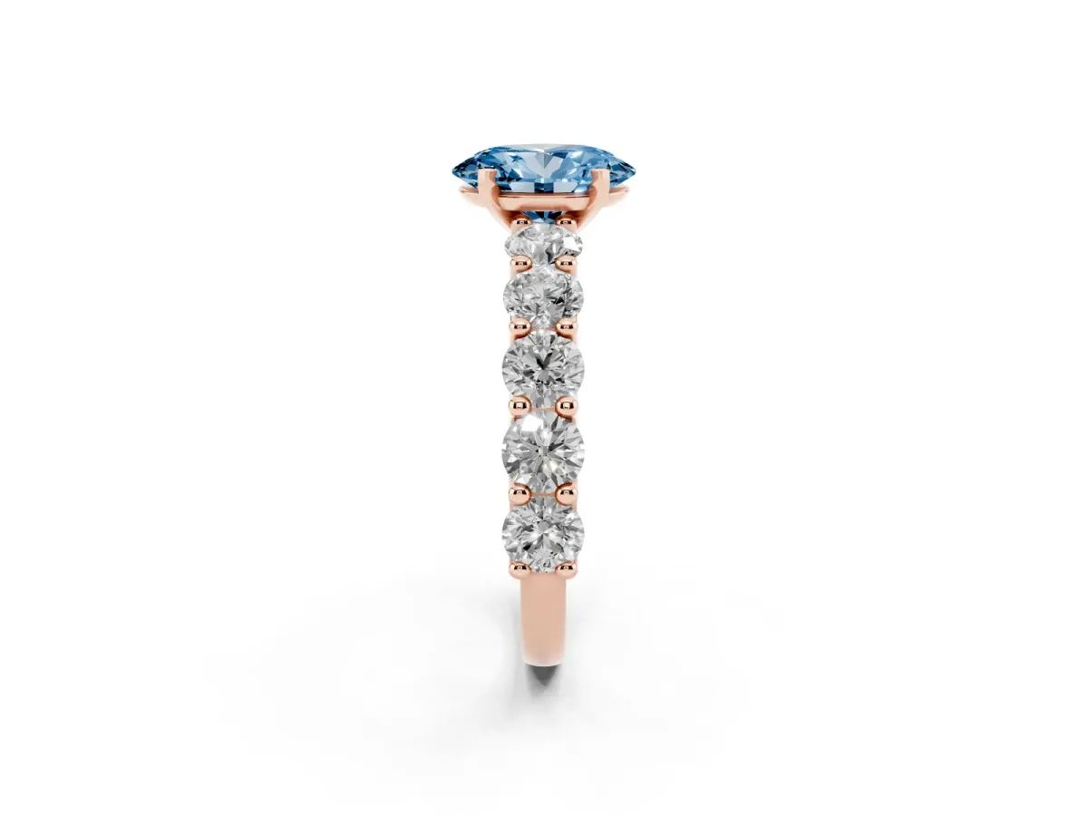 Fancy Blue Oval Cut Diamond Prong Setting with Side Stones on a Pave Band Rose gold