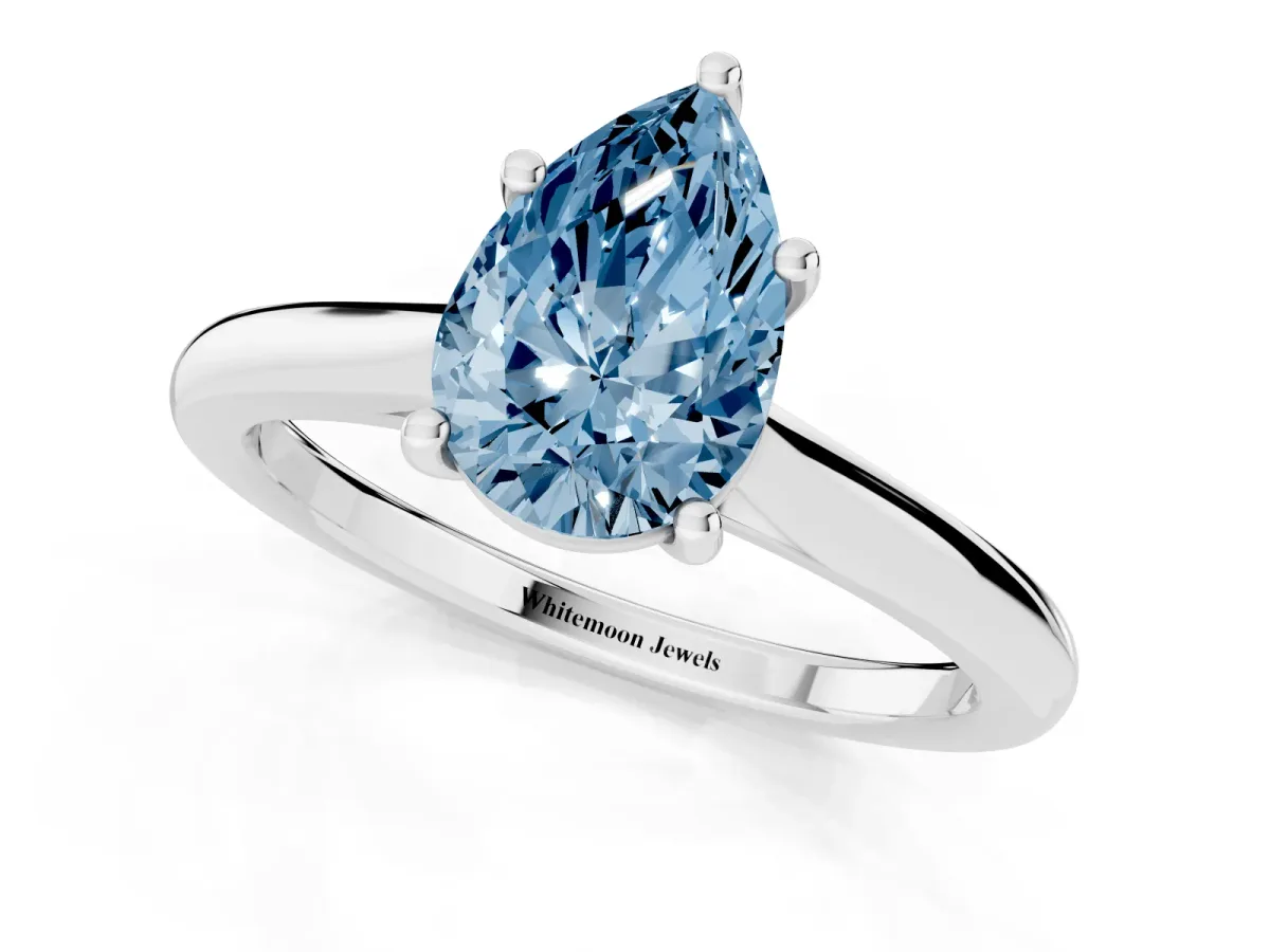 Fancy Blue Pear Cut Cut Solitaire Ring with Cathedral Band and Four-Prong Setting Silver