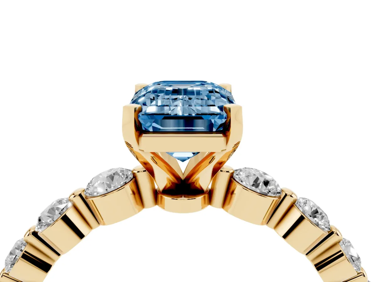 Fancy Blue Emerald Cut Solitaire Diamond Ring with Pave Band and Four-Prong Setting Yellow gold