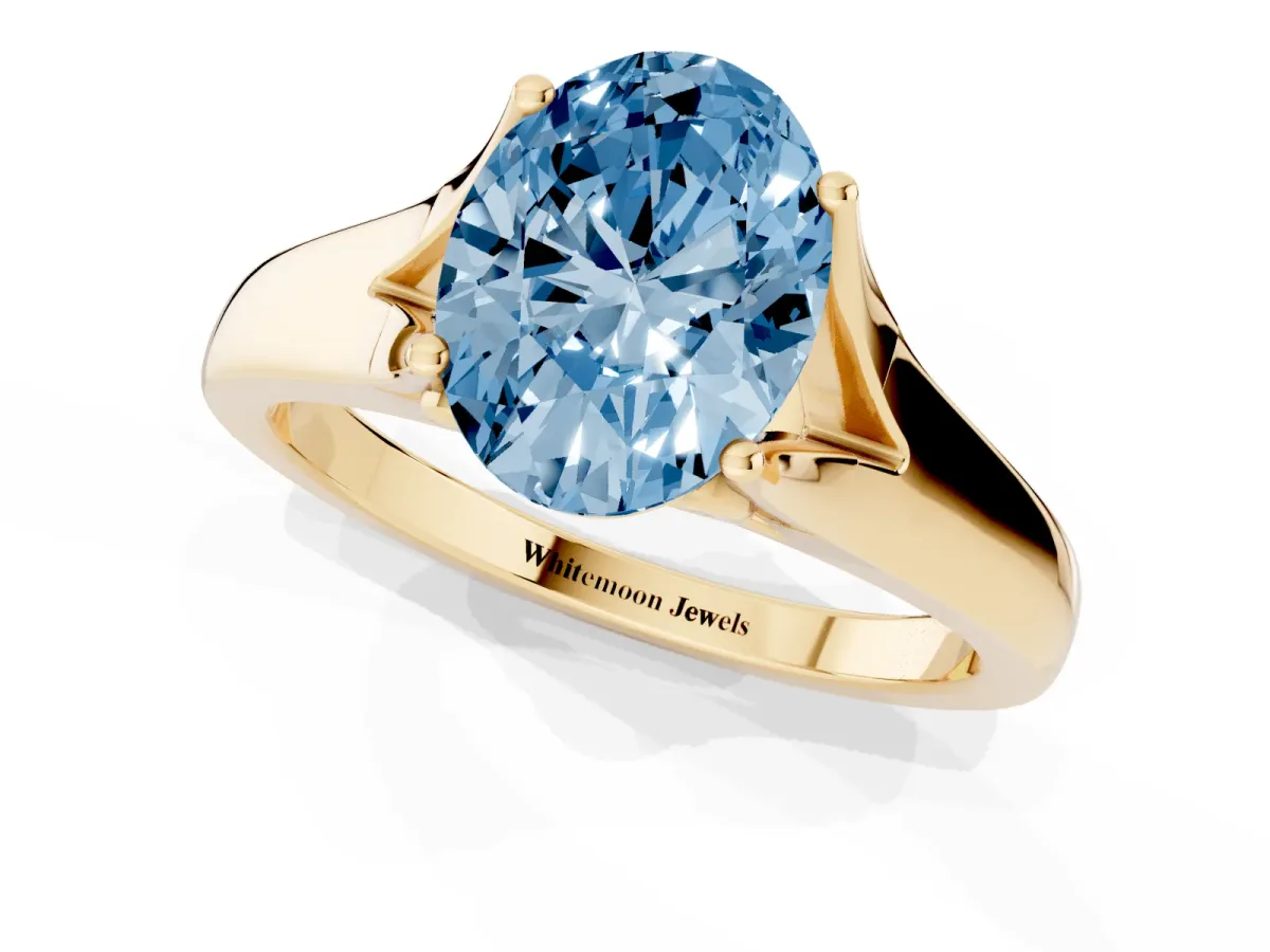 Fancy Blue Oval Cut Solitaire Diamond Ring with Cathedral Band and Four-Prong Setting Yellow gold