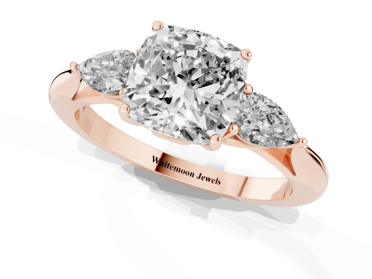 Three-Stone Cushion Cut Diamond Ring with Pear Side Stones in Four-Prong Setting Rose gold