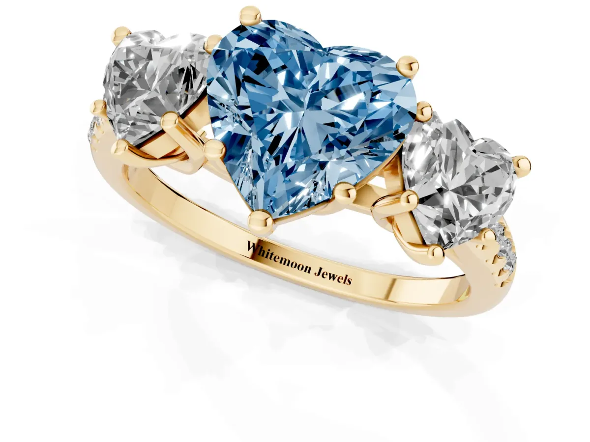 Fancy Blue Three-Stone Heart Cut Diamond Ring with Round Pavé Band and Prong Setting Yellow gold