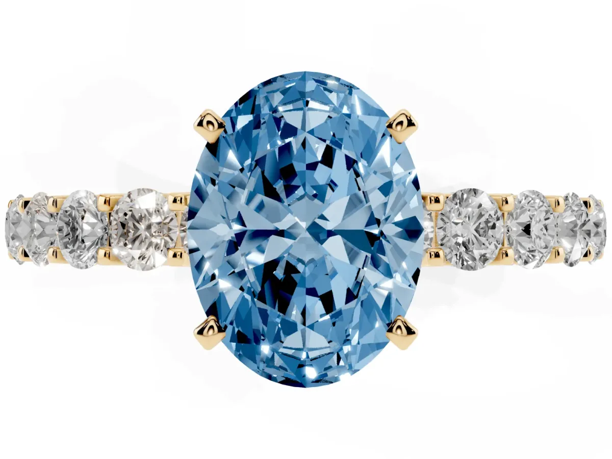 Fancy Blue Oval Cut Diamond Solitaire Ring with Shared Prong Pavé Band and Four-Prong Setting Yellow gold