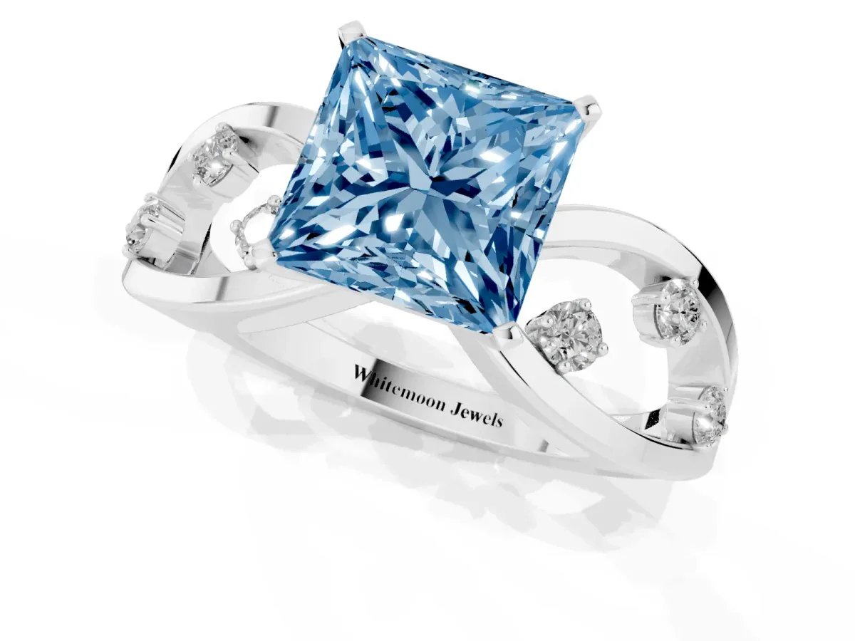 Fancy Blue Princess Cut Cut Solitaire Diamond with Side Stones on Criss-Cross Band and Four-Prong Setting White gold