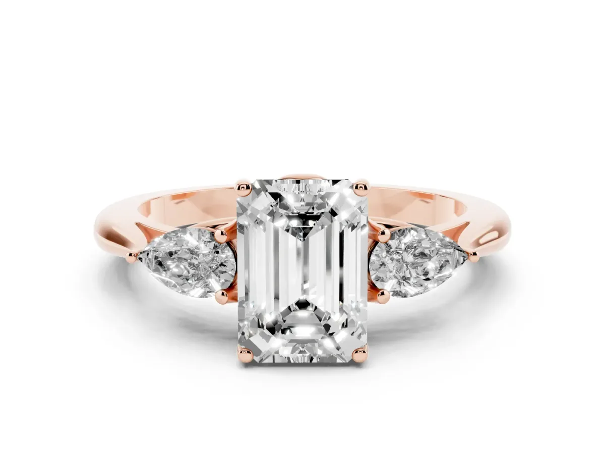 Three-Stone Emerald Cut Diamond Ring with Pear Side Stones in Four-Prong Setting Rose gold
