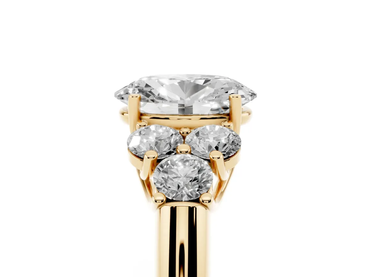 Oval Cut Cut Diamond Cluster Ring with Round Accent Stones and Prong Setting on a Classic Band Yellow gold