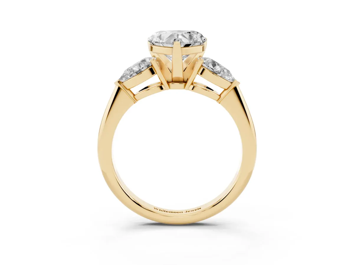 Three-Stone Heart Cut Diamond Ring with Pear Side Stones and Four-Prong Setting Yellow gold