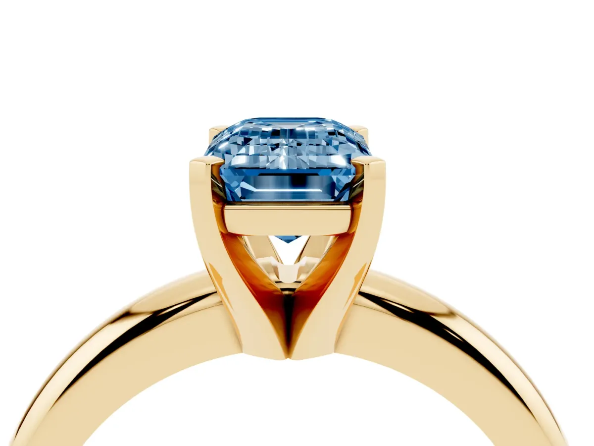Fancy Blue Emerald Cut Diamond Solitaire Engagement Ring with Round Band and Four-Prong Setting Yellow gold