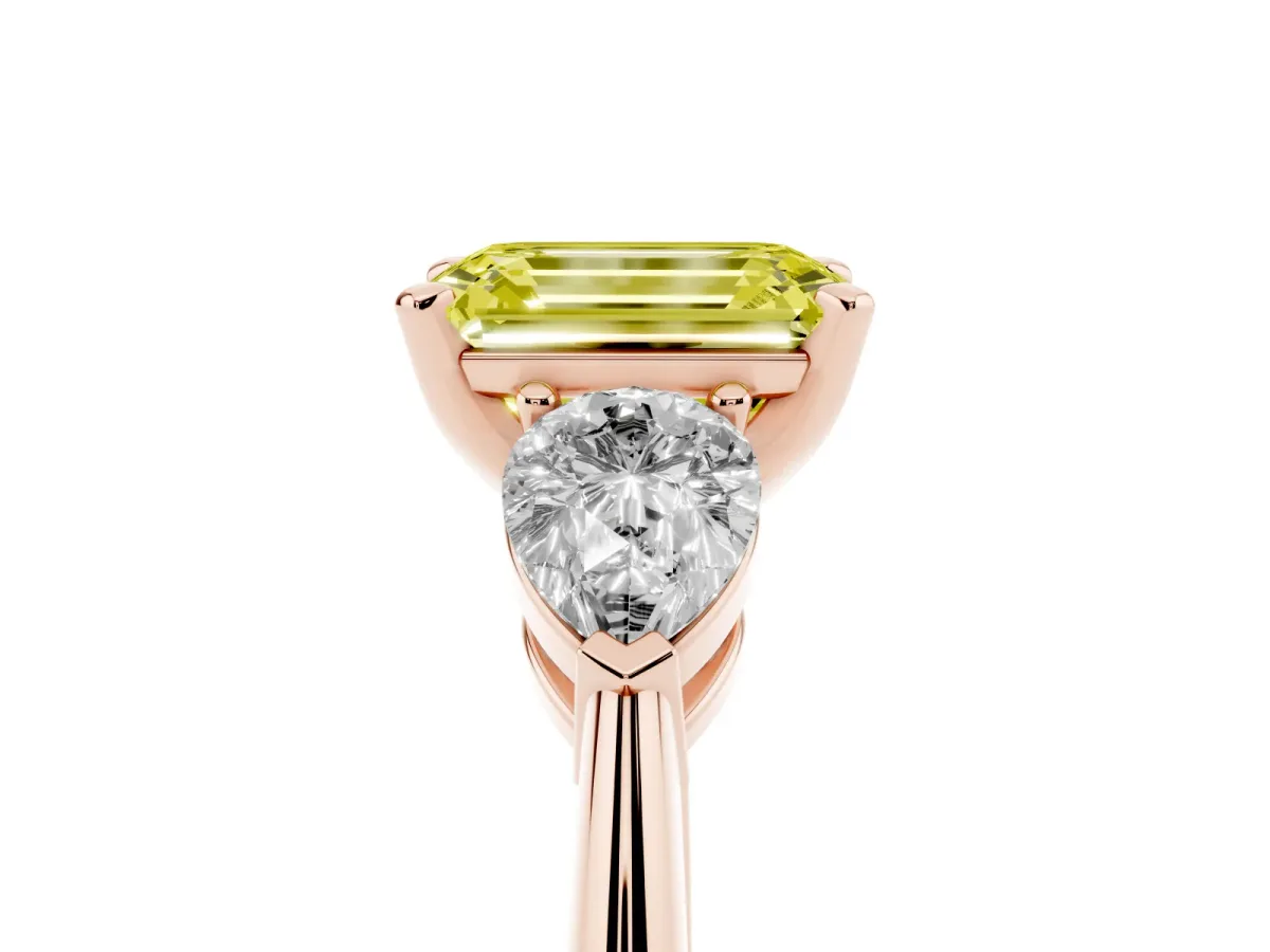 Fancy Yellow Three-Stone Emerald Cut Diamond Ring with Pear Side Stones and Four-Prong Setting Rose gold