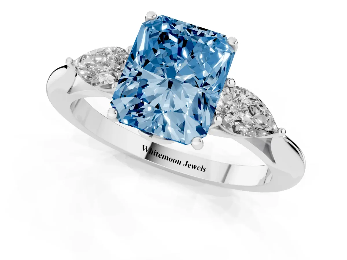 Fancy Blue Three-Stone Radiant Cut Diamond Ring with Pear Side Stones in Four-Prong Setting Platinum
