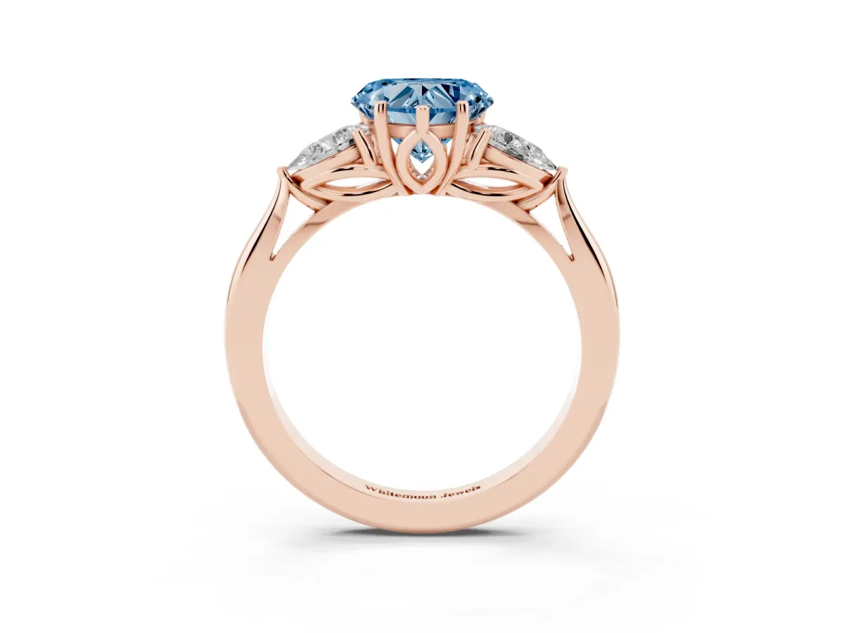 Fancy Blue Three-Stone Heart Cut Diamond Ring with Pear Side Stones in Four-Prong Setting Rose gold