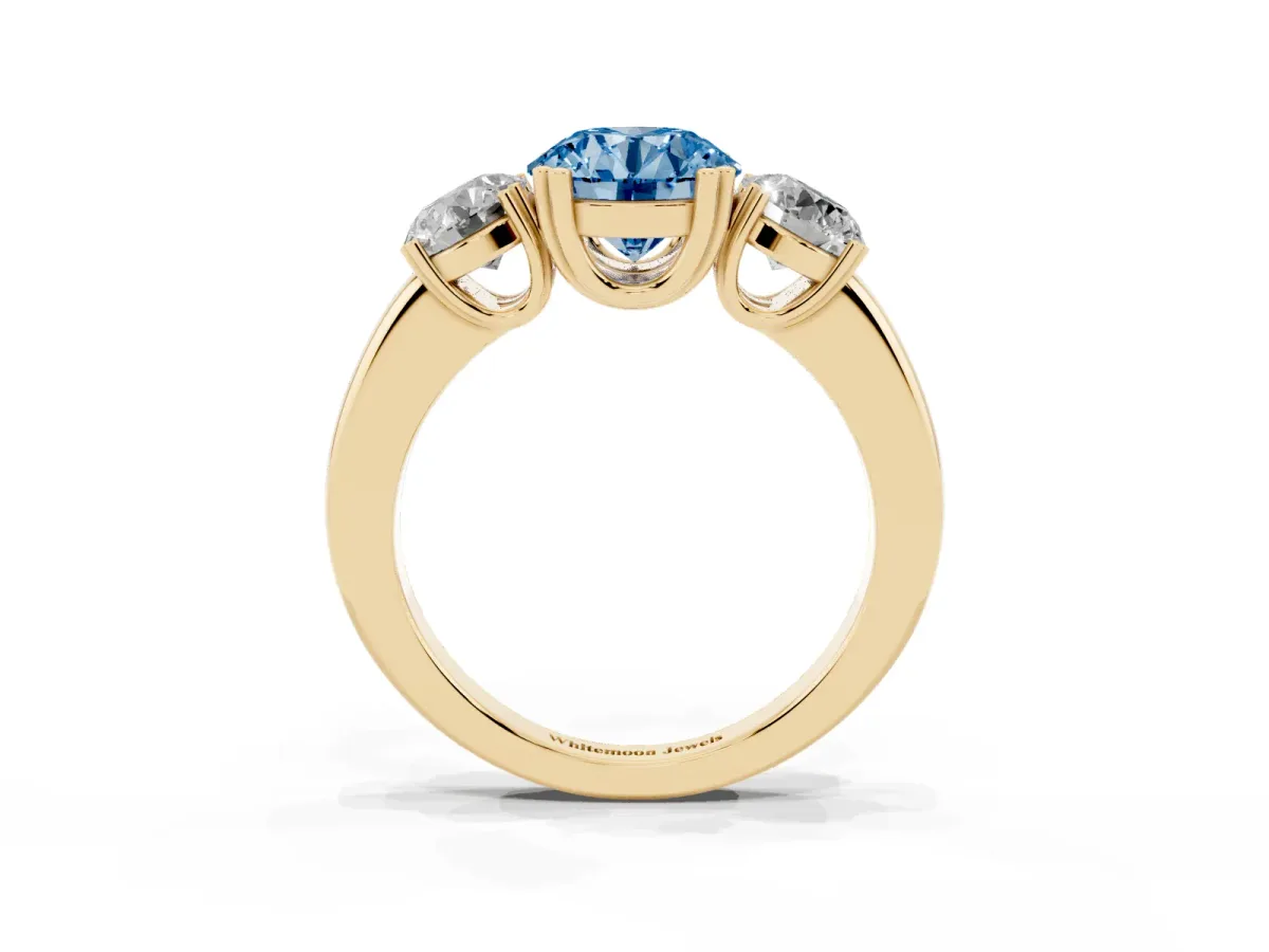 Fancy Blue Three-Stone Round Cut Cut Diamond Ring with Channel Set Band and Four-Prong Setting Yellow gold
