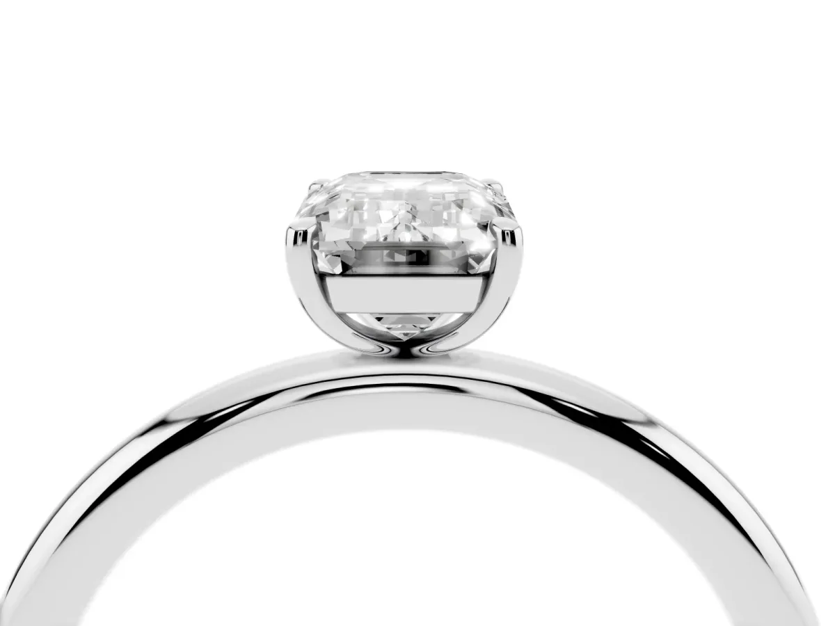 Emerald Cut Solitaire Diamond Ring with Four-Prong Setting on a Plain Band Platinum