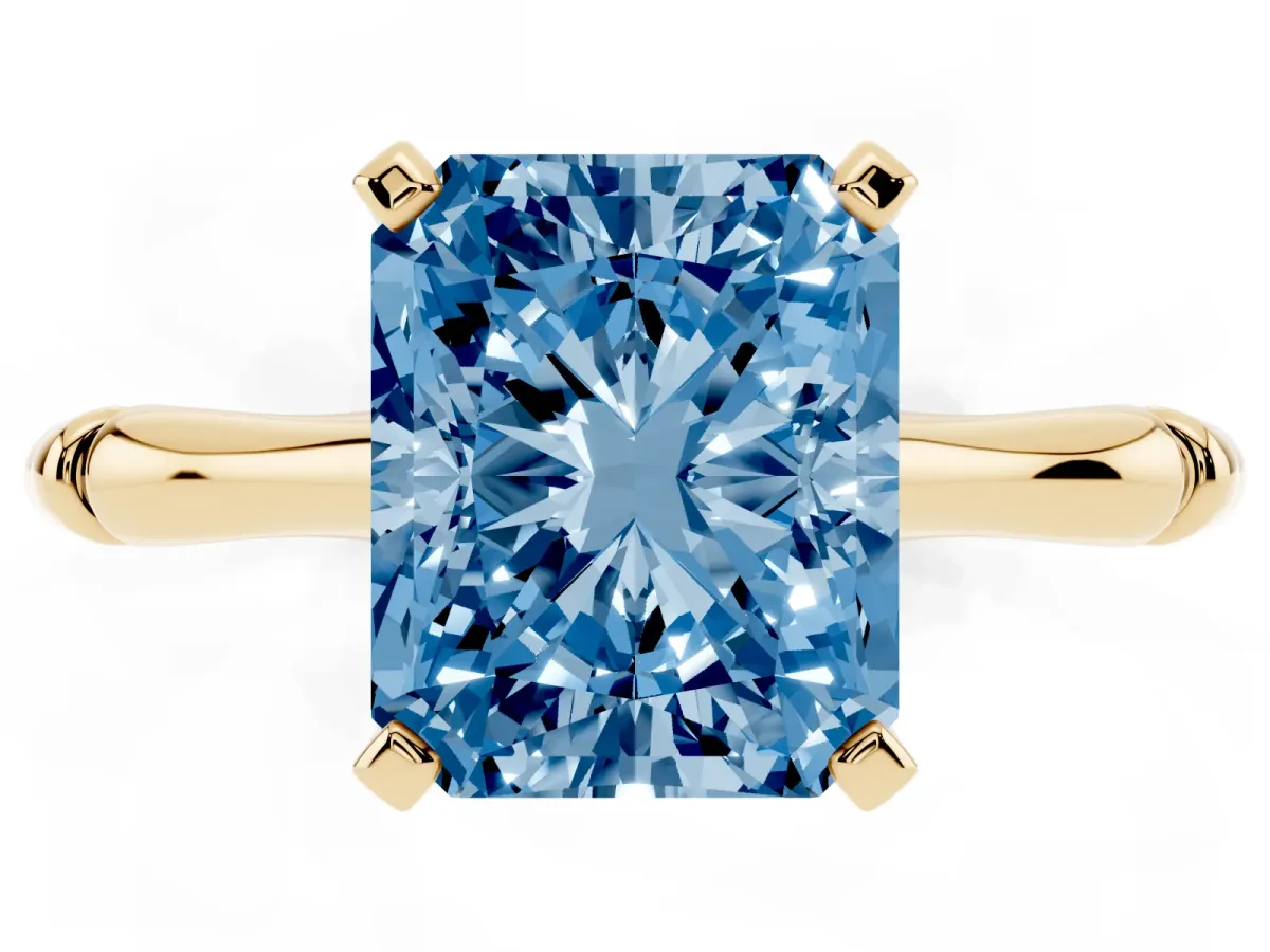 Fancy Blue Radiant Cut Solitaire Diamond Ring with Bamboo Band and Four-Prong Setting Yellow gold