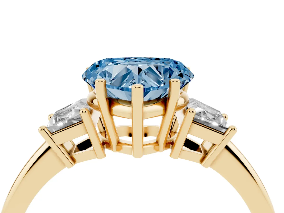 Fancy Blue Heart Cut Diamond Three-Stone Ring with Trapezoid Side Stones and Prong Setting Yellow gold