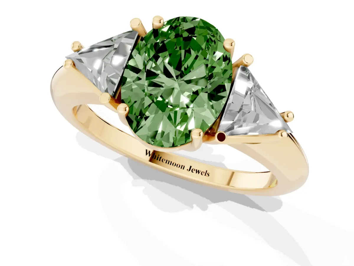 Fancy Green Three-Stone Oval Cut Diamond Engagement Ring with Trillion Side Stones and Prong Setting Yellow gold