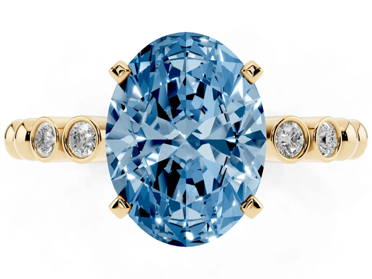 Fancy Blue Oval Cut Solitaire Bezel Accent Diamond Engagement Ring with Beaded Band and Four-Prong Setting Yellow gold