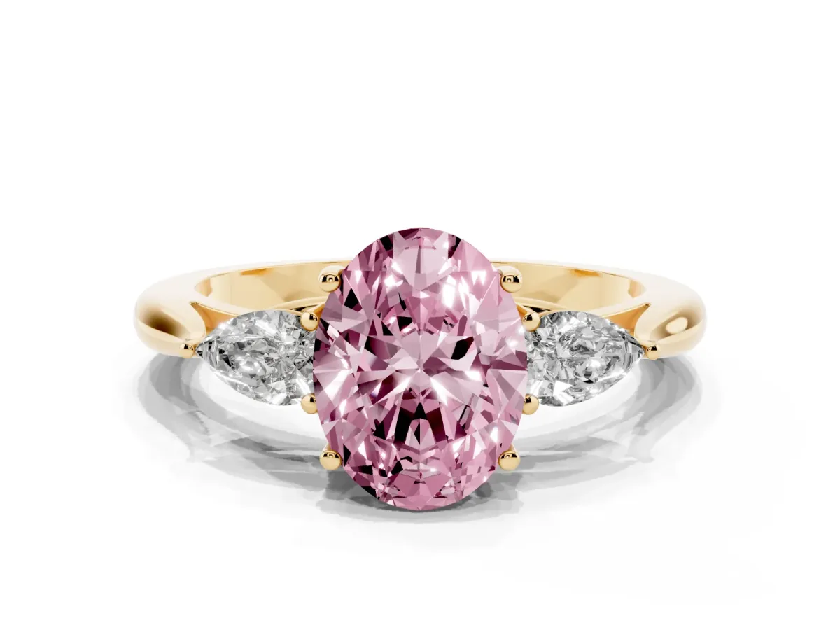 Fancy Pink Oval Cut Diamond Three-Stone Ring with Pear Side Stones and Prong Setting Yellow gold