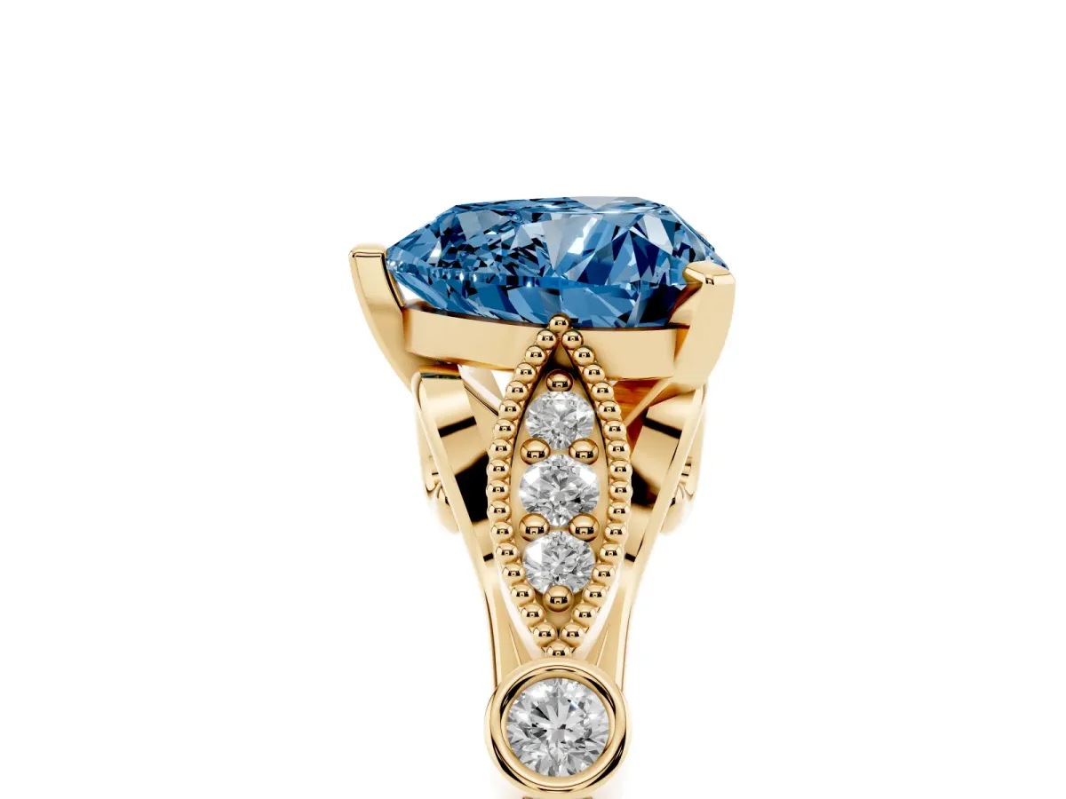 Fancy Blue Heart Cut Cut Diamond with Milgrain Marquise and Bezel Accents on a Solitaire Band with Prong Setting Yellow gold