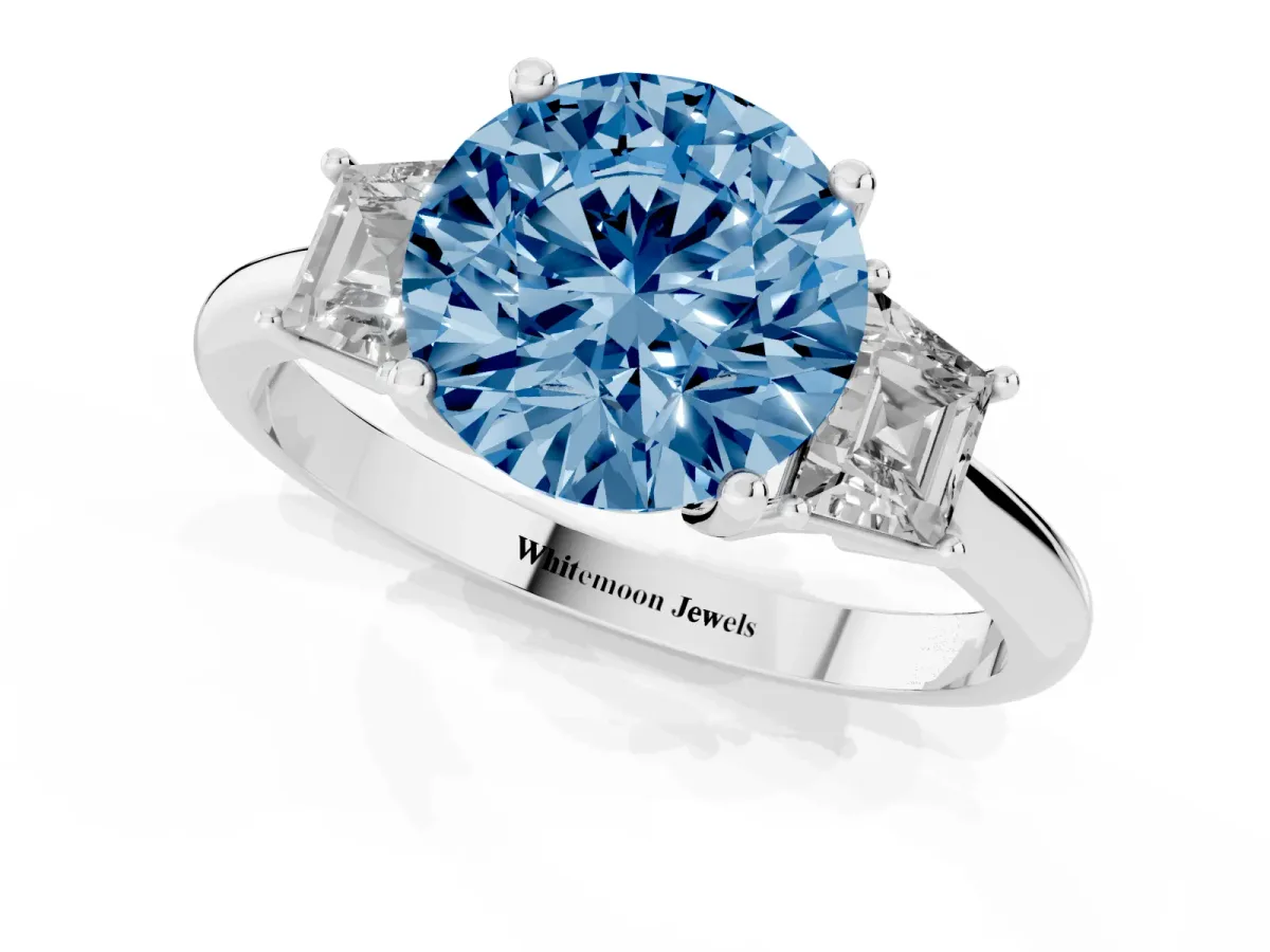 Fancy Blue Round Cut Diamond Three-Stone Ring with Trapezoid Side Stones and Prong Setting Platinum