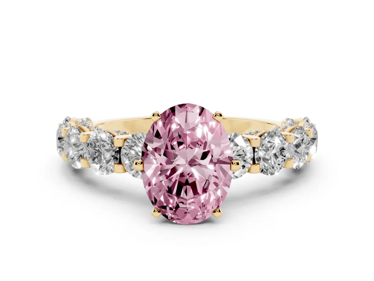Fancy Pink Oval Cut Diamond Side Stone Engagement Ring with Four-Prong Setting Yellow gold
