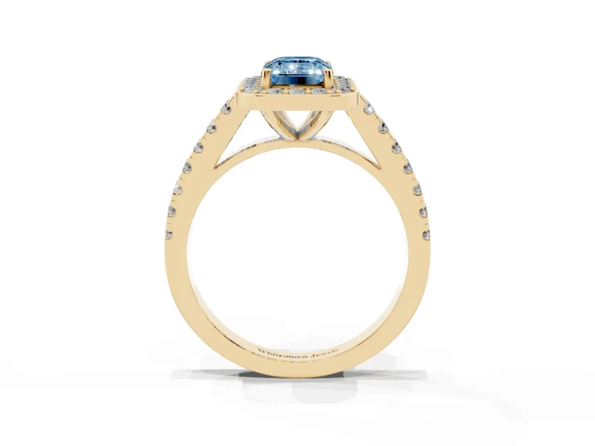 Fancy Blue Emerald Cut Diamond Halo Ring with Round Pavé Split Shank and Prong Setting Yellow gold
