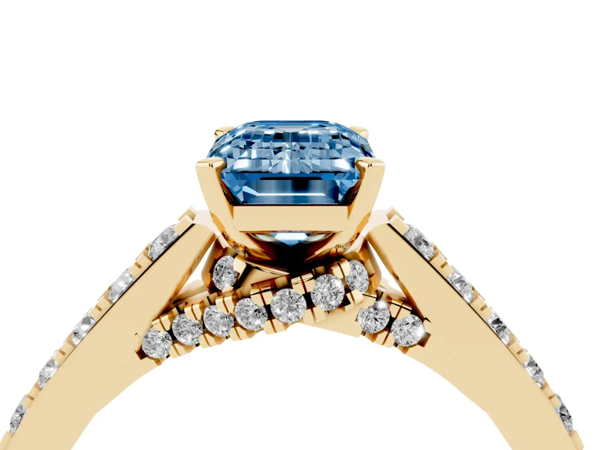 Fancy Blue Emerald Cut Diamond Solitaire Ring with Crossover Gallery and Round Pavé Band Yellow gold