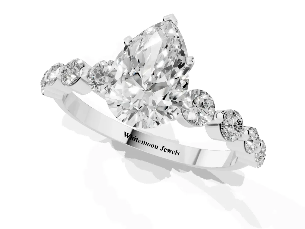 Pear Cut Solitaire Diamond Ring with Pave Band and Four-Prong Setting Silver