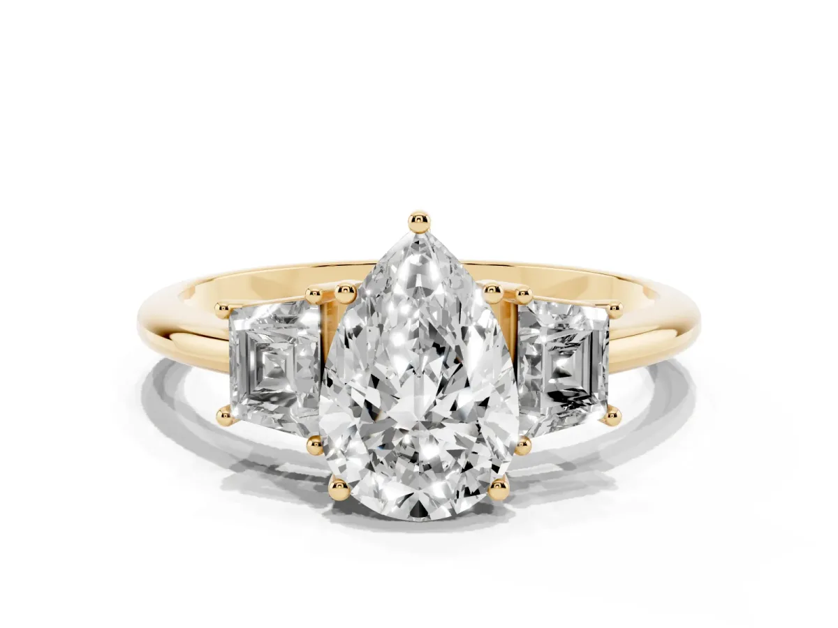Pear Cut Diamond Three-Stone Ring with Trapezoid Side Stones and Prong Setting Yellow gold