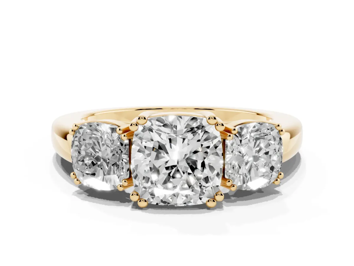 Three-Stone Cushion Cut Cut Diamond Ring with Channel Set Band and Four-Prong Setting Yellow gold