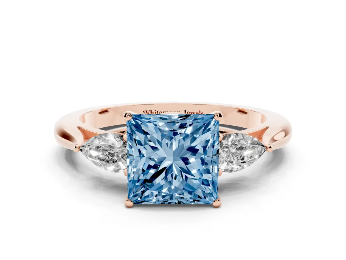 Fancy Blue Three-Stone Princess Cut Diamond Ring with Pear Side Stones in Four-Prong Setting Rose gold