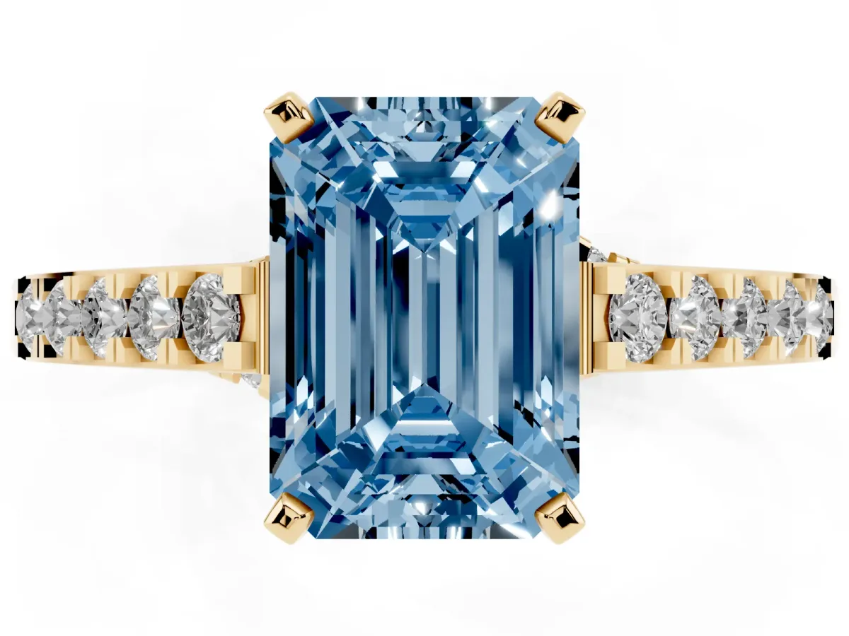 Fancy Blue Emerald Cut Diamond Solitaire Ring with Crossover Gallery and Round Pavé Band Yellow gold