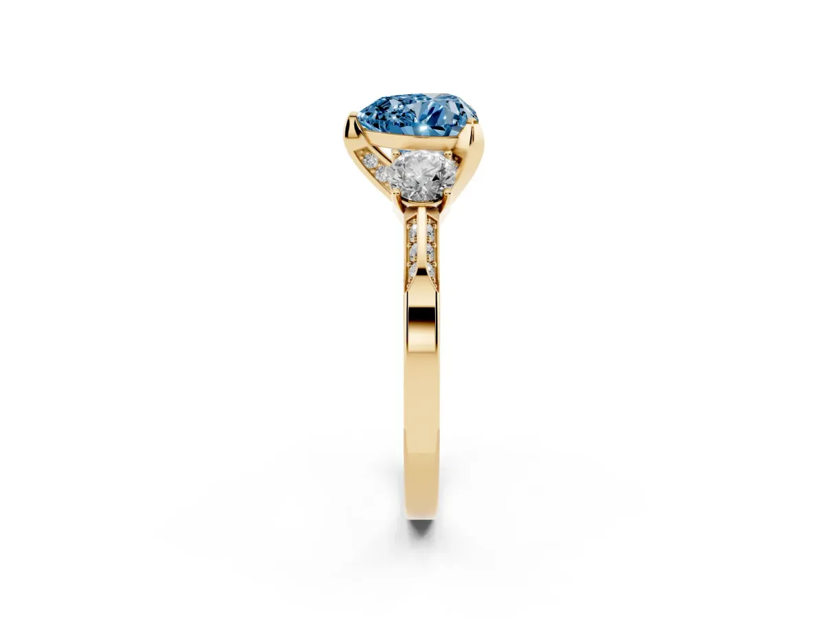 Fancy Blue Heart Cut Brilliant Three-Stone Diamond Ring with Pavé Band and Four-Prong Setting Yellow gold