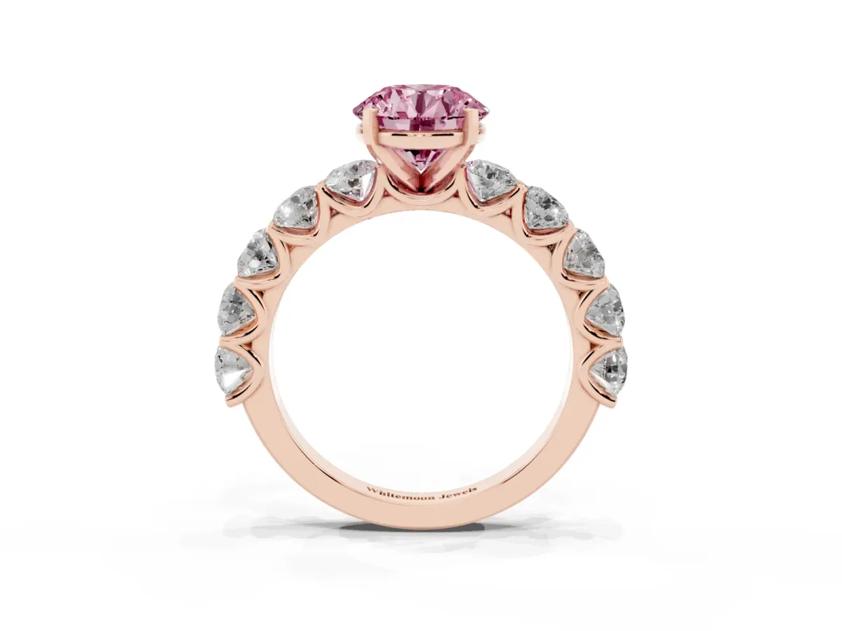 Fancy Pink Round Cut Diamond Prong Setting with Side Stones on a Pave Band Rose gold