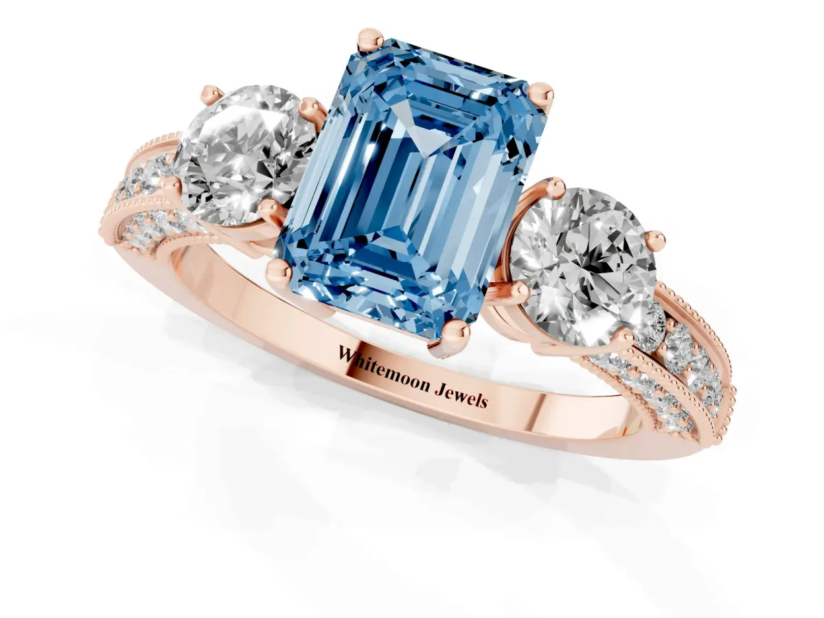 Fancy Blue Emerald Cut Three-Stone Diamond Ring with Pavé Band and Four-Prong Setting Rose gold