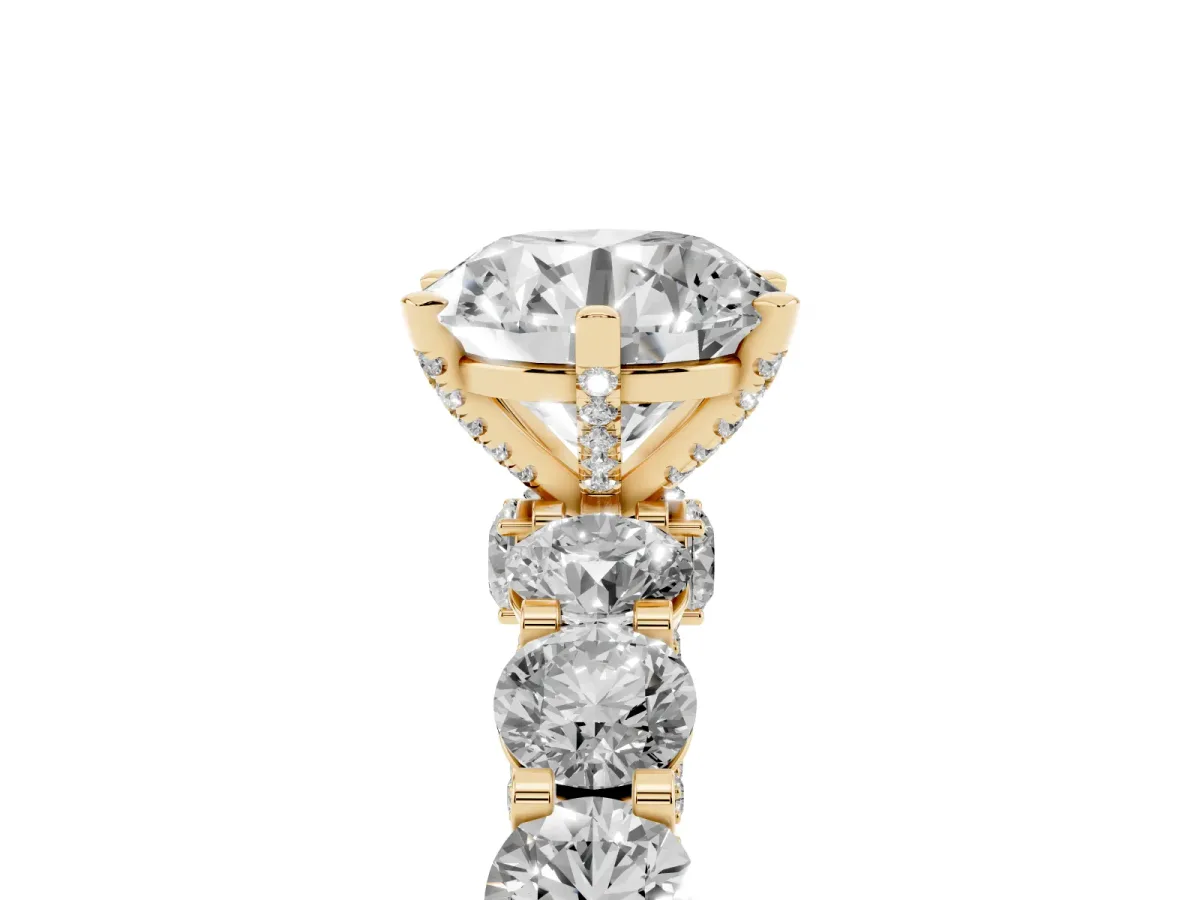 Round Cut Diamond Side Stone Engagement Ring with Four-Prong Setting Yellow gold