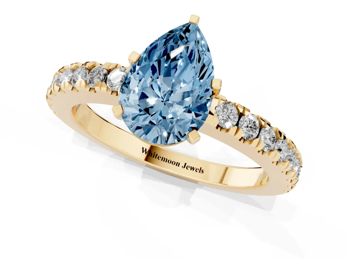 Fancy Blue Pear Cut Solitaire Diamond with Pavé Band and Four-Prong Setting Yellow gold