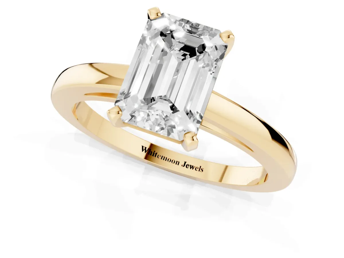 Emerald Cut Solitaire Diamond Engagement Ring with Four-Prong Setting on a Classic Band Yellow gold