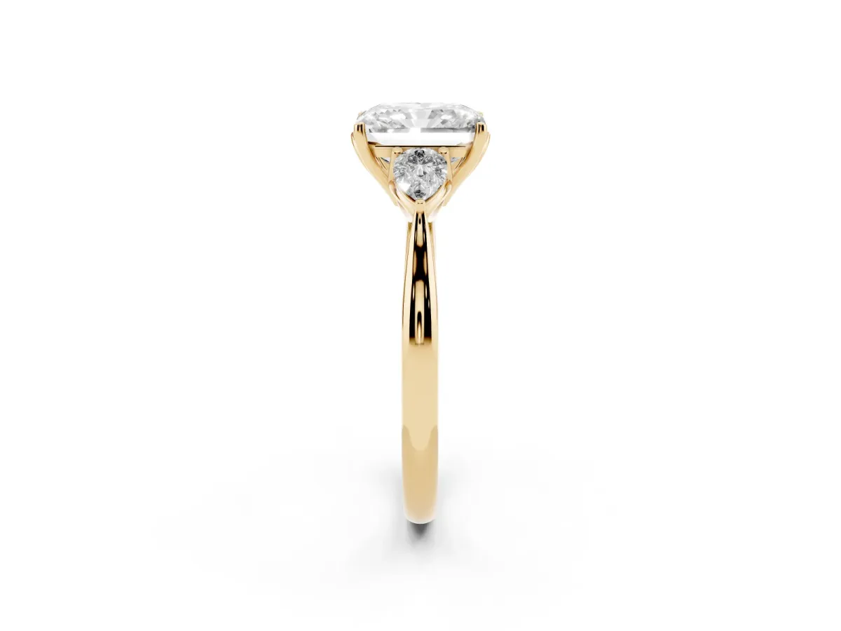 Three-Stone Radiant Cut Diamond Ring with Pear Side Stones in Four-Prong Setting Yellow gold