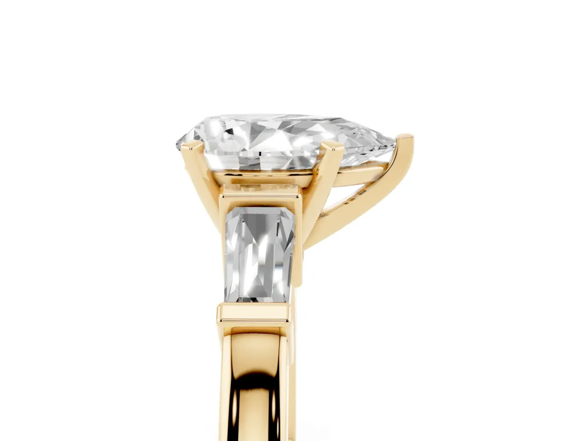 Pear Cut Cut Diamond Solitaire Ring with Tapered Baguette Accents and Four-Prong Setting Yellow gold