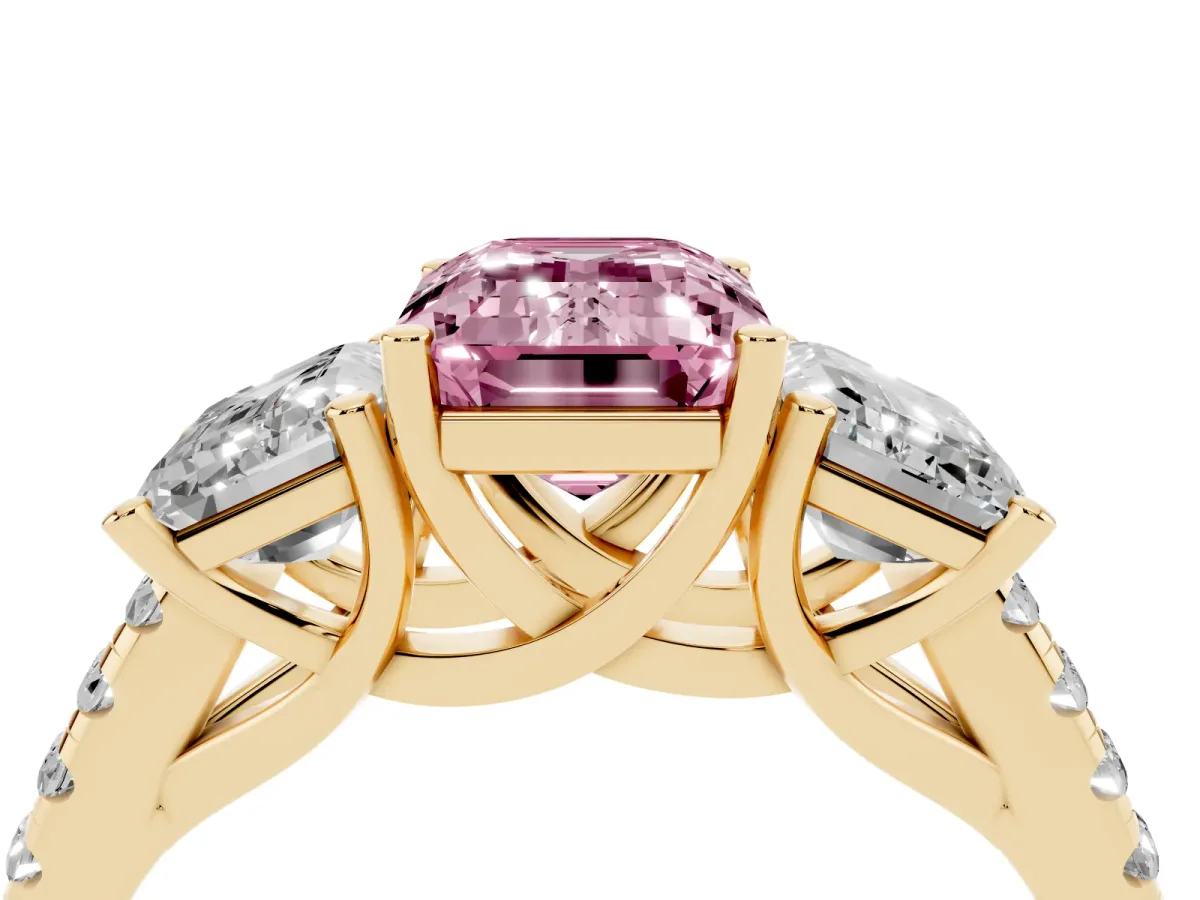 Fancy Pink Three-Stone Emerald Cut Diamond Ring with Round Pavé Band and Prong Setting Yellow gold