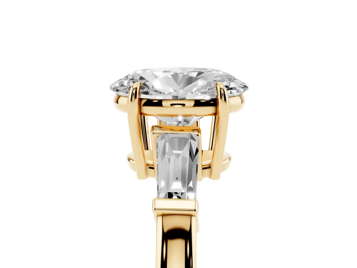 Oval Cut Diamond Three-Stone Ring with Tapered Baguette Side Stones and Prong Setting Yellow gold