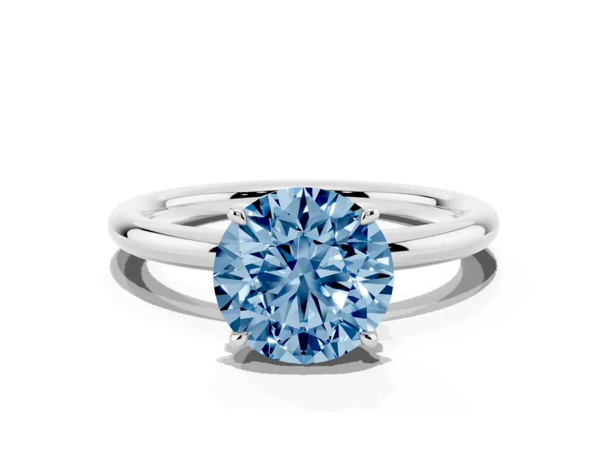 Fancy Blue Round Cut Diamond Solitaire Ring with Thin Band and Four-Prong Setting Silver