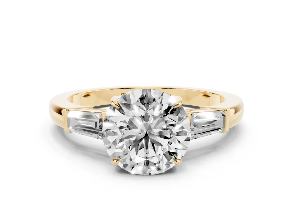 Round Cut Diamond Three-Stone Ring with Tapered Baguette Side Stones and Prong Setting Yellow gold