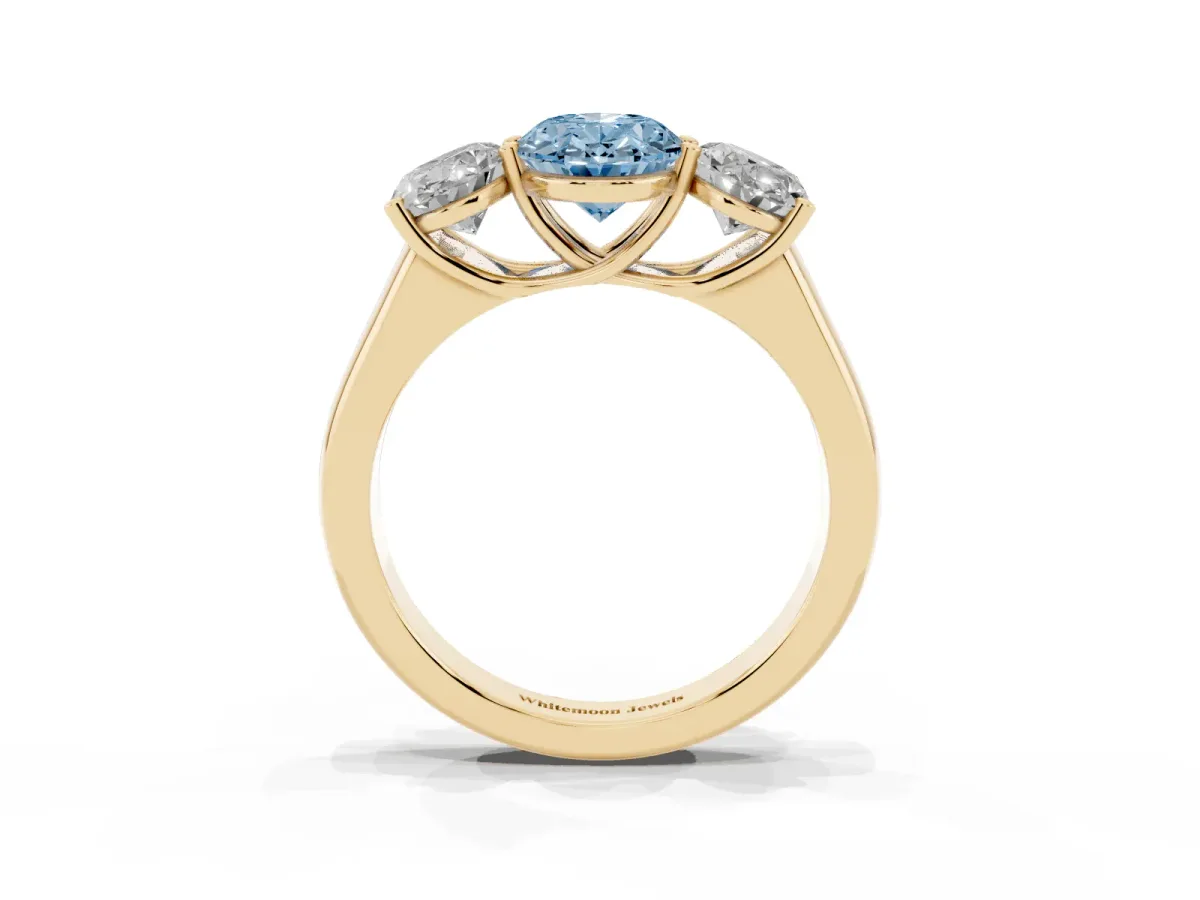 Fancy Blue Oval Cut Three-Stone Diamond Ring with Prong Setting on a Classic Band Yellow gold