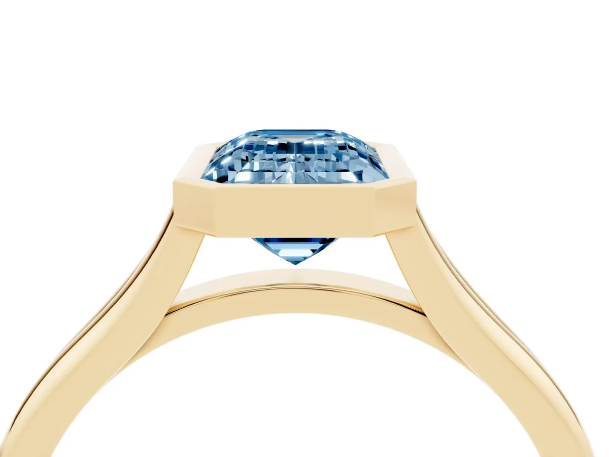 Fancy Blue Bezel Set Emerald Cut Cut Solitaire Ring with Tapered Band Yellow gold