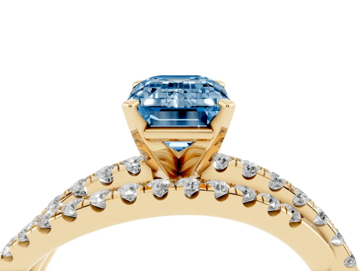 Fancy Blue Emerald Cut Solitaire Twist Band with Pavé Setting and Four-Prong Setting Yellow gold