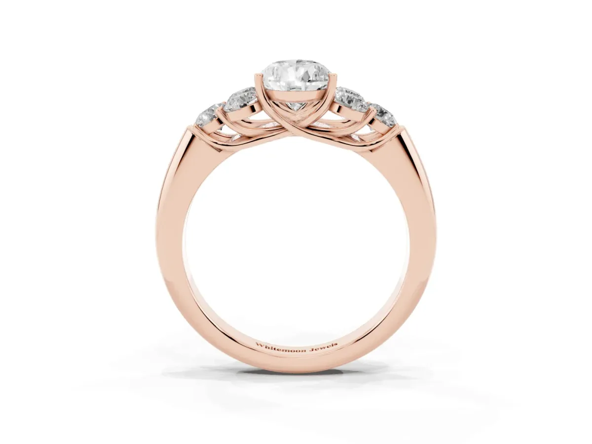 Pear Cut Cut Diamond Cluster Ring with Round Accent Stones and Prong Setting on a Classic Band Rose gold
