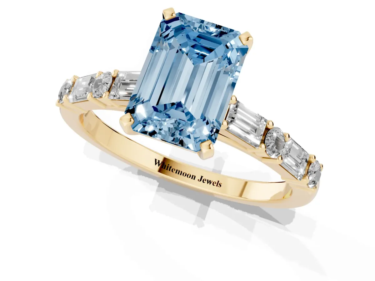 Fancy Blue Emerald Cut Diamond Solitaire with Side Baguettes and Channel Set Band Yellow gold